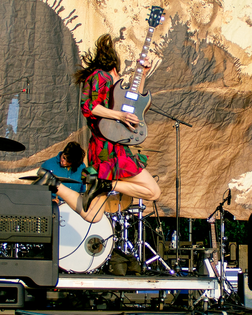 Carrie Brownstein jumps in the air at Riot Fest